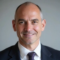 Portrait of John Smith, CEO of ProStay Solutions, a confident and experienced business leader.